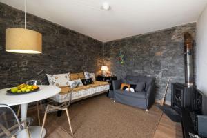 a living room with a couch and a table at Casinha dos Canhas by An Island Apart in Ponta do Sol +36 photos