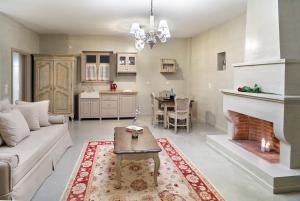 a living room with a couch and a fireplace at Haones Suites in Ioannina