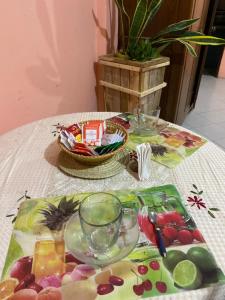 a table with a plate of fruit and glasses on it at Brisas del rio in Formosa