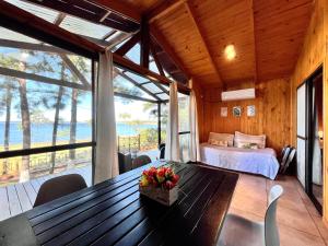 a bedroom with a bed and a table with flowers on it at Blusky Lodge in Puerto Iguazú