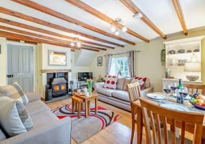 a living room with a couch and a table at Wren Cottage - Bedale in Hornby