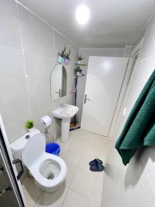 a white bathroom with a toilet and a sink at Cente ville House in Agadir