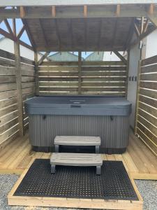a bench sitting in front of a hot tub at Portaferry self catering retreat in Portaferry