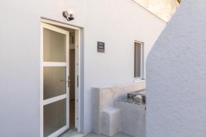 an open door in a white room with a sink at Seaview Vela Luka in Vela Luka +22 photos