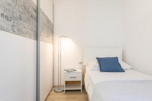 a small bedroom with a bed and a mirror at Seaview Vela Luka in Vela Luka