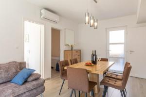 a living room with a wooden table and a couch at Seaview Vela Luka in Vela Luka