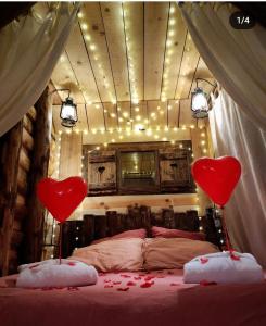 a bedroom with two hearts on top of a bed at La mine de Buck in Le Biot