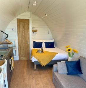 a bedroom with a bed and a table and a couch at Pentire Coastal Holiday Park in Bude