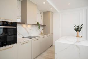 a white kitchen with a sink and a stove at Villa Artis in Pula
