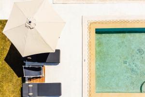 a view of a pool and a chair next to a door at AlexMare Hotel Fourka in Skala Fourkas