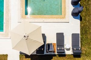 an overhead view of an umbrella next to a pool at AlexMare Hotel Fourka in Skala Fourkas