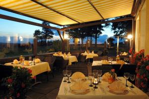 ein Restaurant mit Tischen und weißen Tischdecken in der Unterkunft Hotel Berghof in Seiffen