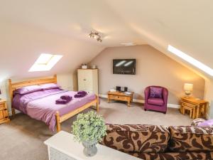 a bedroom with a bed and a couch at Barn Owl Annex in Market Rasen