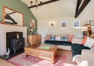 a living room with a couch and a fireplace at Woodpecker View in Kirby Misperton