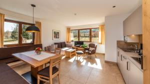 a kitchen and living room with a table and chairs at Residence Tolderhof - Olang in Valdaora