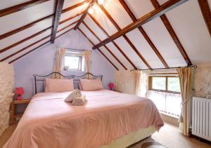 a bedroom with a large bed in a attic at Woodpecker Cottage in Hutton le Hole