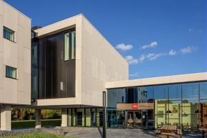 a large building with glass windows on the side of it at ibis Brussels Groot Bijgaarden in Groot-Bijgaarden