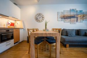 a kitchen and living room with a table and a couch at Seemeile in Büsum