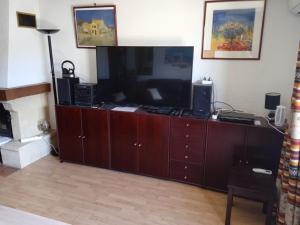 a large entertainment center with a flat screen tv and speakers at Village Naturiste Cap d'Agde Luvitere in Cap d'Agde