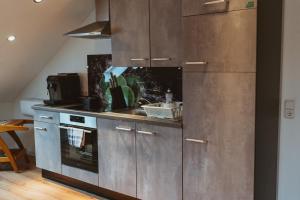 a kitchen with stainless steel cabinets and a stove at Kleine Auszeit in Ellzee