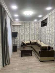 a living room with a couch and a table at Apartment in Monument in Yerevan