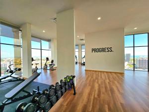 an empty gym with a sign that reads progress at Quartz Paragon Suites By GGM in Melaka