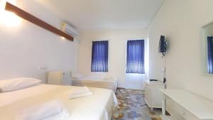 Ένα ή περισσότερα κρεβάτια σε δωμάτιο στο Hotel Tropicana