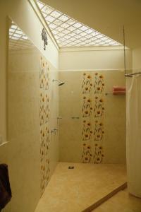 a bathroom with a shower with a shower curtain at Copperhill- A Luxury Homestay in Madikeri