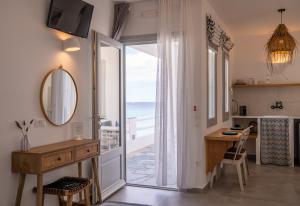 a room with a desk and a view of the ocean at Ammos Sifnos Village in Platis Gialos