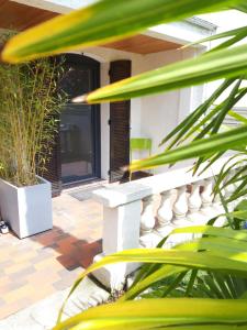 a porch with a bench and some plants at T2 Rungis Mermoz Lenôtre Orly in Rungis