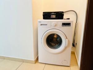 a washing machine in a corner of a room at New! Royal family ground apartment 2BR in Bat Yam