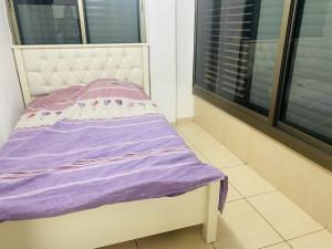a small bed in a room with a window at New! Royal family ground apartment 2BR in Bat Yam