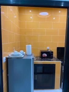 a kitchen with a counter top with a toaster and a stove at Dakar-Sénégal mini studio chambre toilette cuisine in Dakar