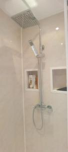 a shower with a shower head in a bathroom at Beautifully designed private studio in Telford near M54 J4 in Telford