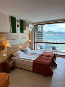 A bed or beds in a room at Briz Beach apartments - section B