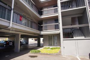an apartment building with a parking lot and a garage at Hualalai 307 Thirty One Day Minimum in Hilo