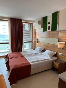 A bed or beds in a room at Briz Beach apartments - section B