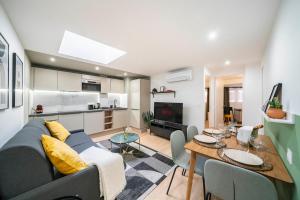 a living room with a couch and a table at 5mn à pied Monaco - Hypercentre - AQ in Beausoleil +21 photos