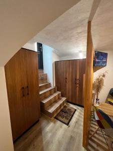 a staircase in a room with wooden cabinets at TimHouse in Timişoara