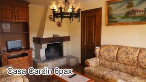a living room with a couch and a fireplace at Casa Cardin in Cangas de Onís