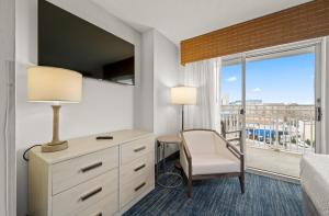 a hotel room with a bed and a desk and a window at Hotel Monte Carlo Ocean City in Ocean City