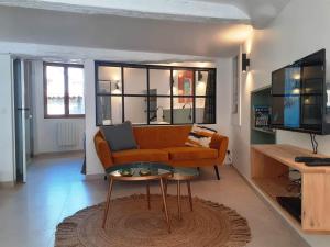a living room with a couch and a table at Apartement Victor in Tourtour