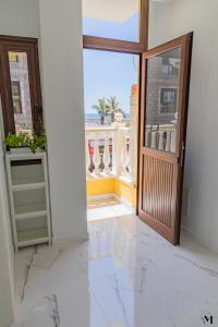 an open door with a view of a balcony at Aqua Vista Playa San Juan in Playa de San Juan