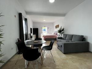 a living room with a couch and a table and chairs at Studio Home Away from Home in Caniçal