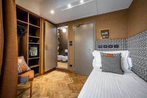 a small room with a bed and a chair at Hotel Duomo Firenze in Florence