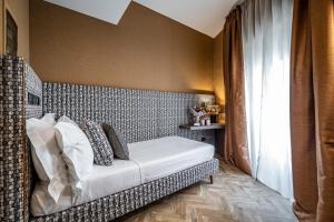 Postel nebo postele na pokoji v ubytování Hotel Duomo Firenze
