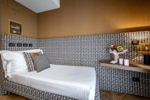 Postel nebo postele na pokoji v ubytování Hotel Duomo Firenze