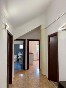 a hallway with two doors and a bathroom at Apartament Central in Constanţa