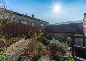 a garden in front of a brick house at Watercrag in Gunnerside