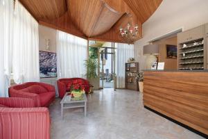 Una sala de estar con sillas rojas y una mesa. en Appartamento Bilocale Moneglia 31, en Moneglia